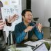 Engaged team members in a lively office meeting discussing startup ideas and innovation.