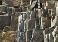 Close-up of a textured stone rock formation, showcasing natural geological structures.