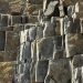 Close-up of a textured stone rock formation, showcasing natural geological structures.
