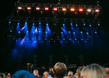 Night concert scene with audience, stage, and colorful lighting effects.