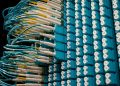 From below of fiber optic equipment with similar colorful rubber cables and round sockets