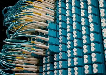 From below of fiber optic equipment with similar colorful rubber cables and round sockets