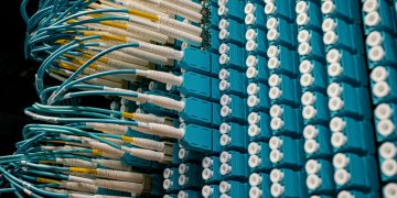 From below of fiber optic equipment with similar colorful rubber cables and round sockets