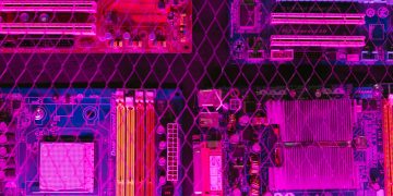 Colorful circuit boards behind a wire mesh, enhanced with pink and purple hues.