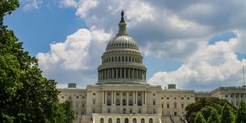 A stunning view of the iconic United States Capitol under a blue sky in Washington, D.C.