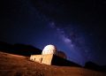 Stunning view of the Milky Way galaxy above a desert observatory under a starry night.