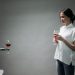 A robot presents a glass of wine to a woman, showcasing modern technology and interaction.