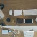Top-down view of an organized modern desk setup featuring Apple devices and accessories.