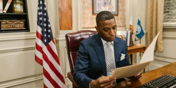 A professional man in a law office reads a document, symbolizing focus and diligence.