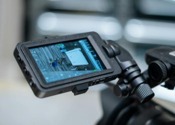 Close-up view of a camera monitor displaying captured footage with detailed settings.
