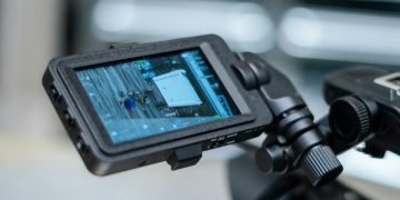 Close-up view of a camera monitor displaying captured footage with detailed settings.