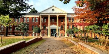 A beautiful university building in Daegu, South Korea, surrounded by autumn foliage.