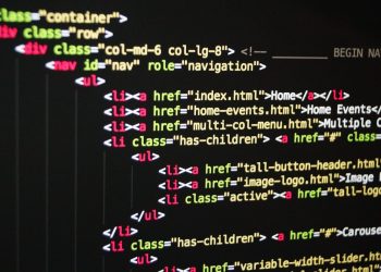 Close-up of vibrant HTML code displayed on a computer screen, showcasing web development and programming.