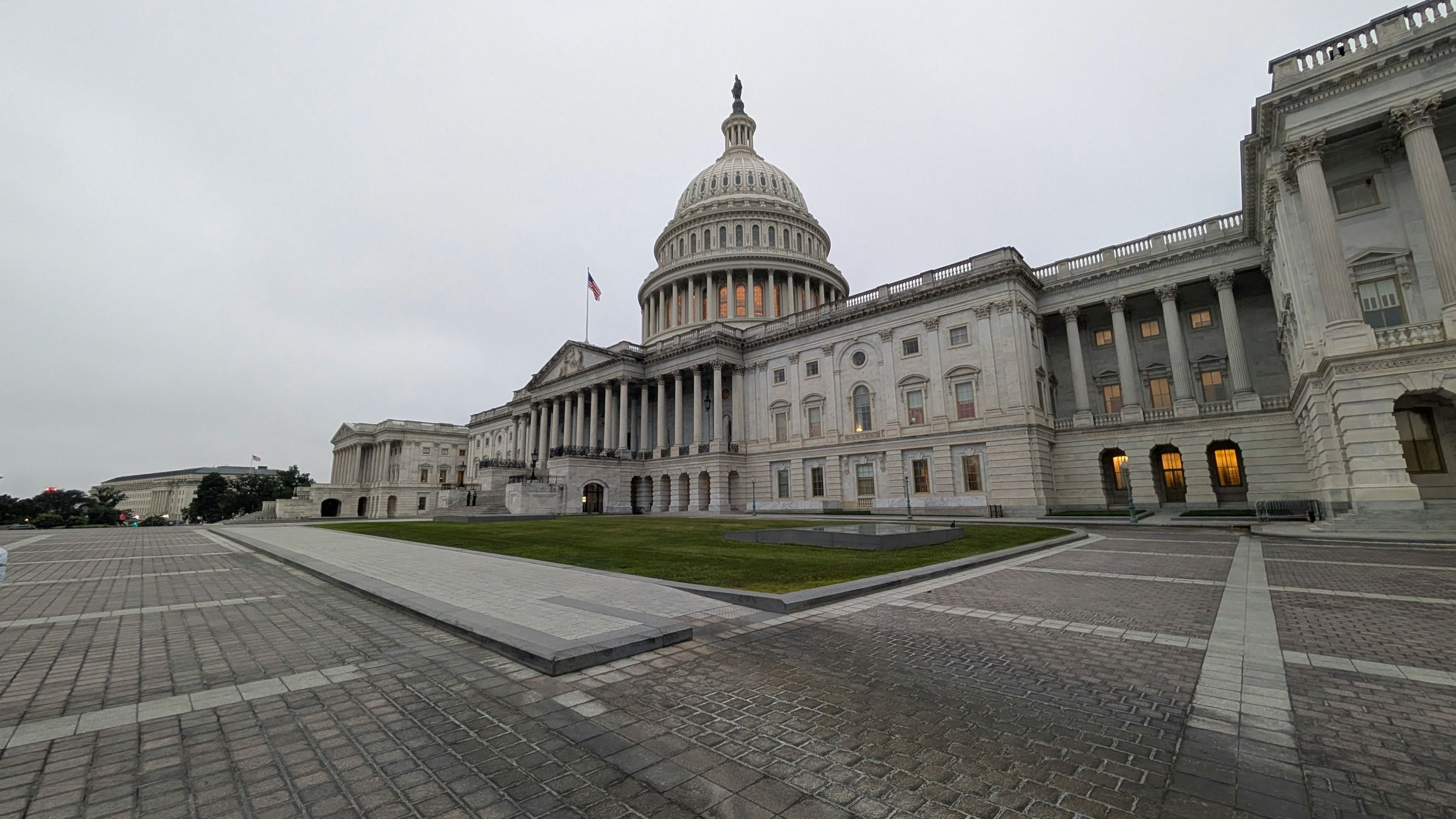 View of the iconic US Capitol Building in Washington, DC on a cloudy day.