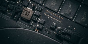 Detailed macro shot of electronic circuit board showing microchips and components.