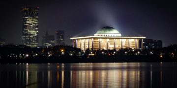 Stunning cityscape featuring a well-lit domed building and skyline at night.