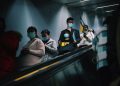 People wearing masks on an escalator in Shanghai during pandemic times.