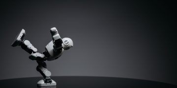 Minimalist photo of a toy robot balancing creatively in a studio setting.