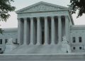 Front view of the iconic Supreme Court building with classical columns and majestic architecture.