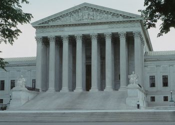 Front view of the iconic Supreme Court building with classical columns and majestic architecture.