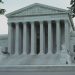 Front view of the iconic Supreme Court building with classical columns and majestic architecture.