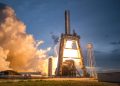 A dramatic shot of a SpaceX rocket launch against a colorful dusk sky, depicting power and technology.