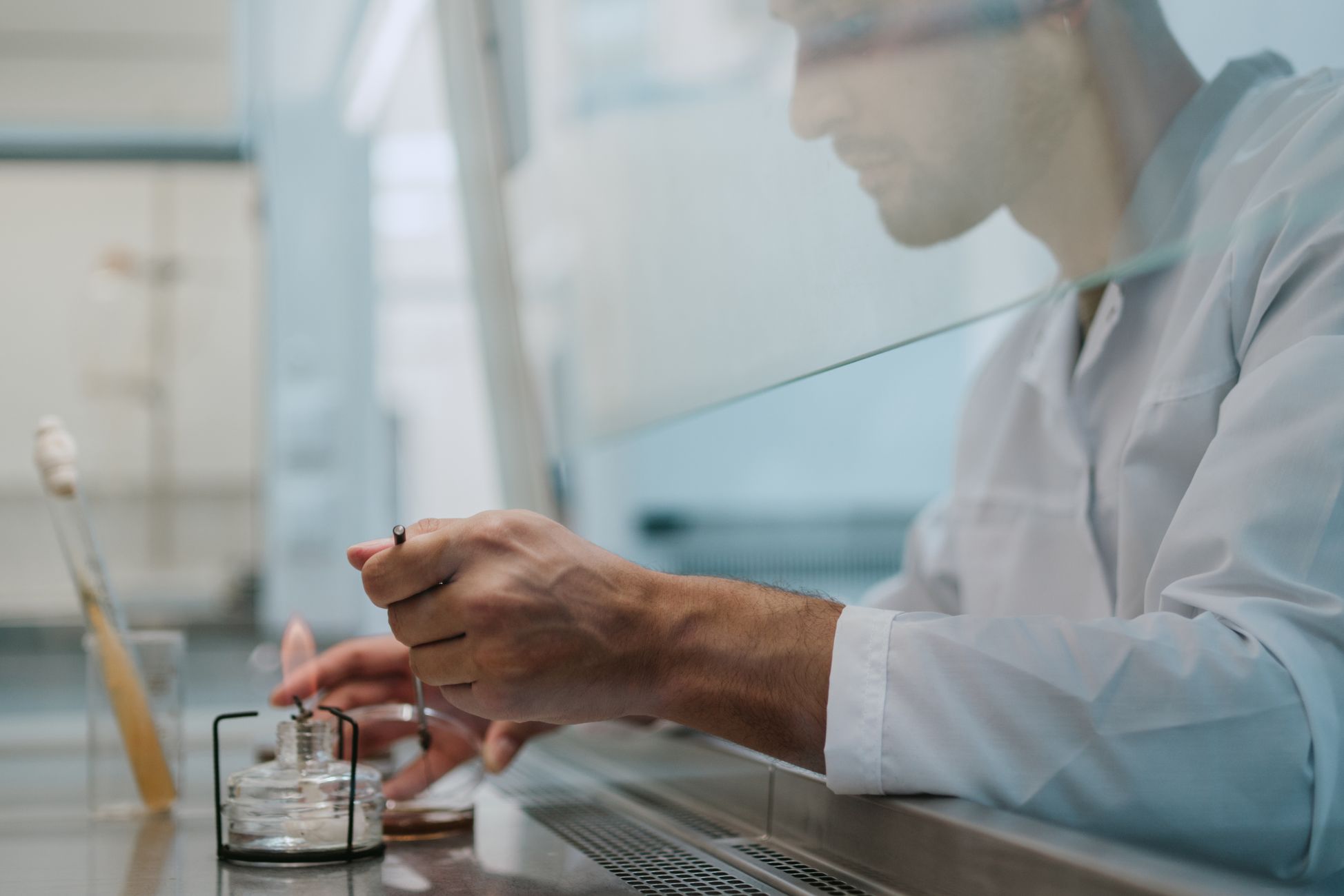 A scientist conducting an experiment in a lab, focusing on precision and safety.