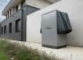 Innovative heat pump system by alpha innotec installed outside a contemporary building.