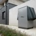 Innovative heat pump system by alpha innotec installed outside a contemporary building.