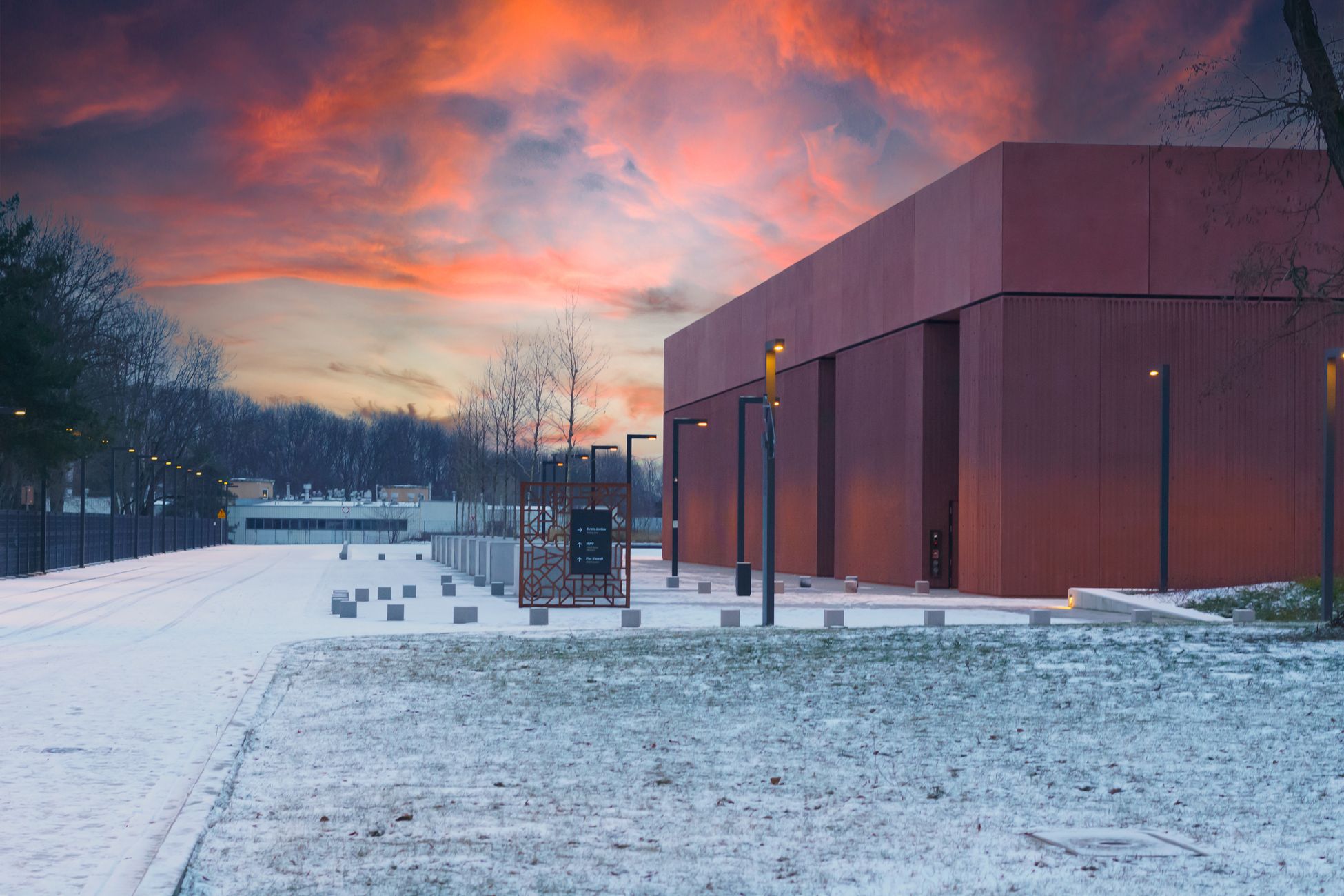 A modern building exterior in Warsaw during winter at sunset, showcasing a serene and vibrant atmosphere.