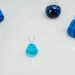 Various glass flasks filled with blue liquid in a scientific setting, perfect for research themes.