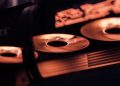 Dynamic close-up shot of illuminated gaming graphics card fans in red light, showcasing cutting-edge technology.