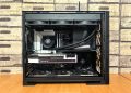 Detailed view of a custom-built gaming PC with visible components like graphics card and cooling system.