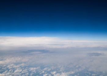 High-altitude view revealing the vastness of the sky with serene clouds.