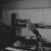 Artistic black and white shot of a music studio with a focus on a microphone. Perfect for music-themed projects.