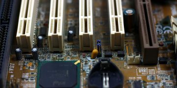 Detailed close-up of computer motherboard showing components like RAM slots and capacitors.