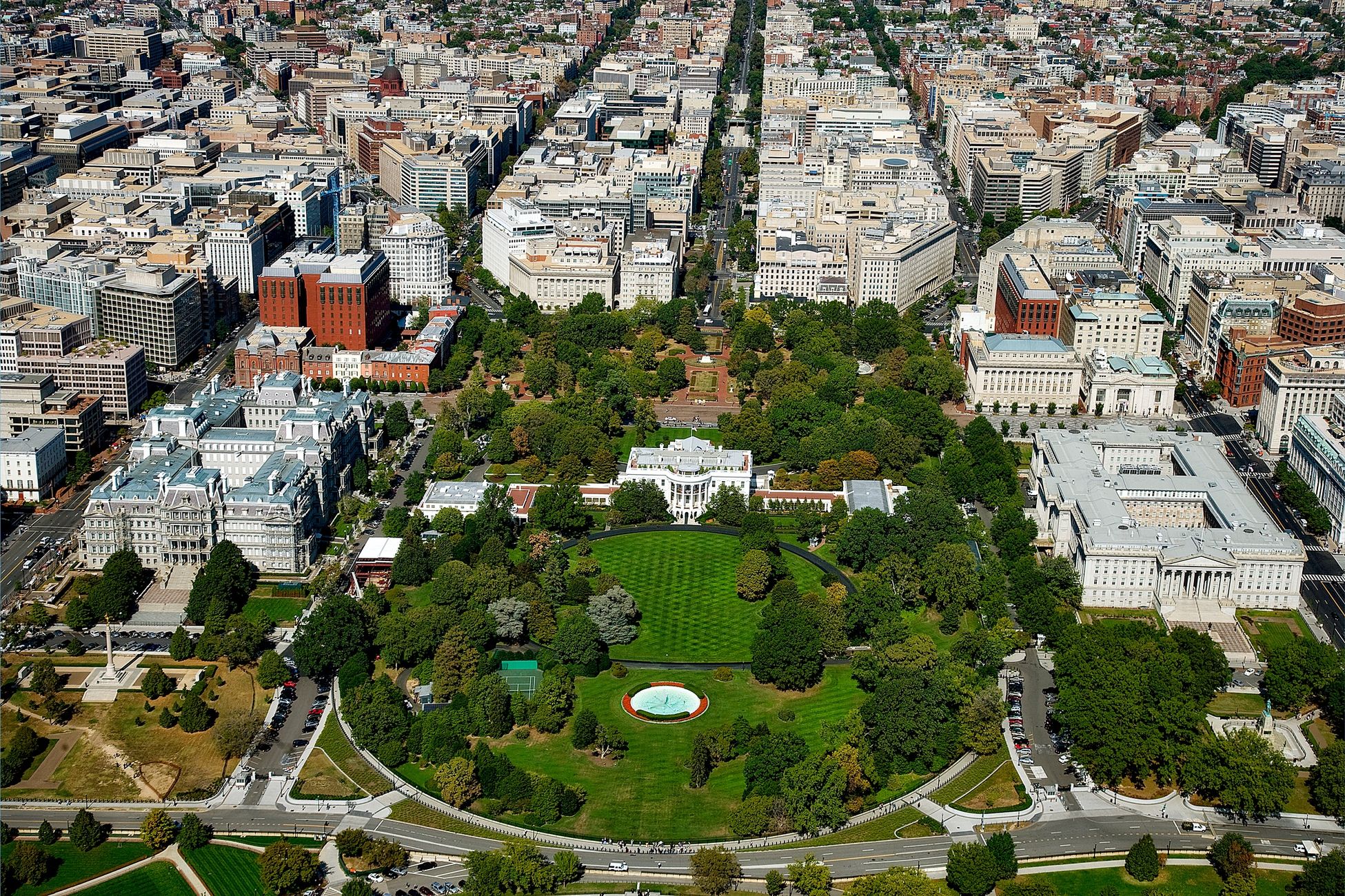 A stunning aerial view of The White House surrounded by downtown Washington D.C.'s architecture and green spaces.