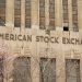 Facade of the American Stock Exchange Building in New York City during spring with blooming trees.