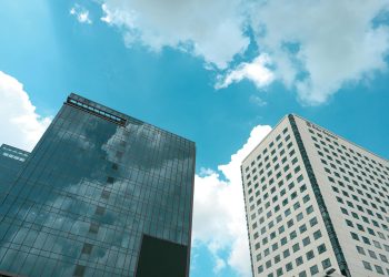 Low angle view of modern high-rise buildings and cloudy sky in Yangon, Myanmar.
