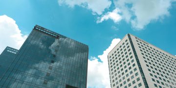 Low angle view of modern high-rise buildings and cloudy sky in Yangon, Myanmar.