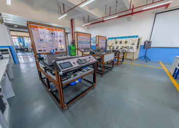 Spacious engineering laboratory equipped with advanced training systems and desks.