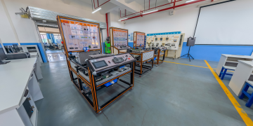 Spacious engineering laboratory equipped with advanced training systems and desks.