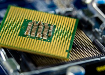 Detailed close-up of a microprocessor on a motherboard showcasing its intricate design.