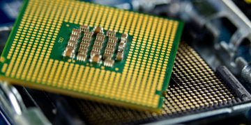 Detailed close-up of a microprocessor on a motherboard showcasing its intricate design.