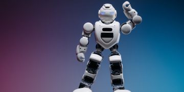 A sleek white robot in a studio setting against a gradient background, showcasing modern robotics.