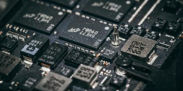Detailed close-up of electronic microchips on a circuit board, showcasing technology and engineering intricacies.