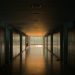 Peaceful school corridor at sunset with lockers and soft lighting.