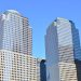 Stunning low-angle view of modern skyscrapers in downtown New York under a clear blue sky.