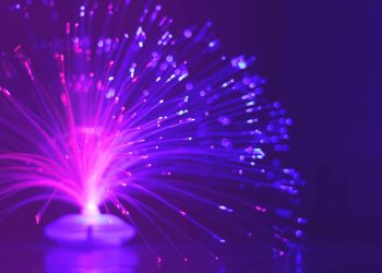 Abstract image of a vibrant purple and pink fiber optic light glowing at night.