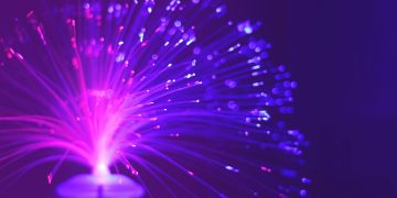 Abstract image of a vibrant purple and pink fiber optic light glowing at night.